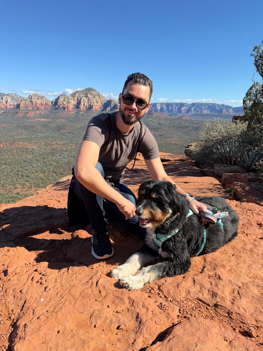 Brandon, the B in Busy B, on a red-rock overlook with his dog